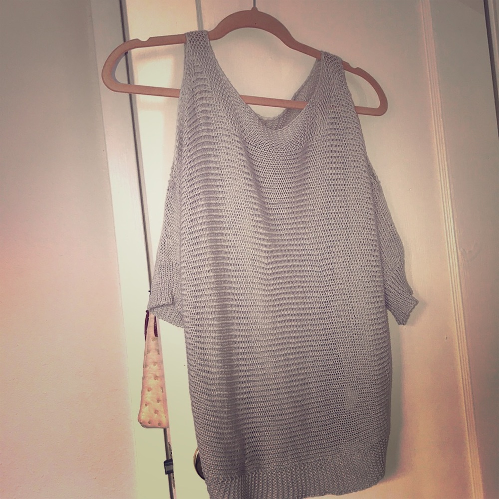 Light grey knit top. Cutout shoulder piece